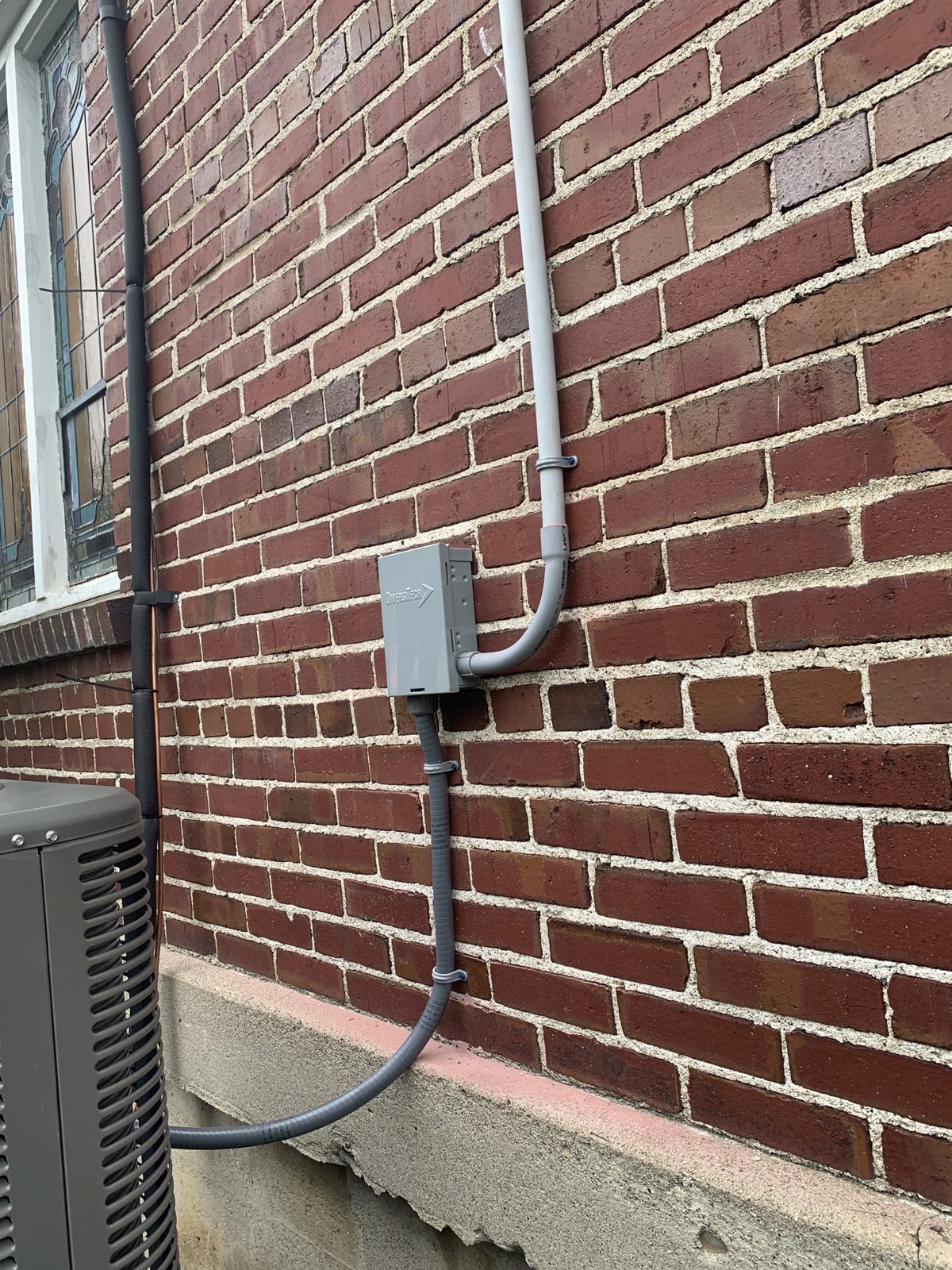 Exterior electrical service mounted cleanly on brick